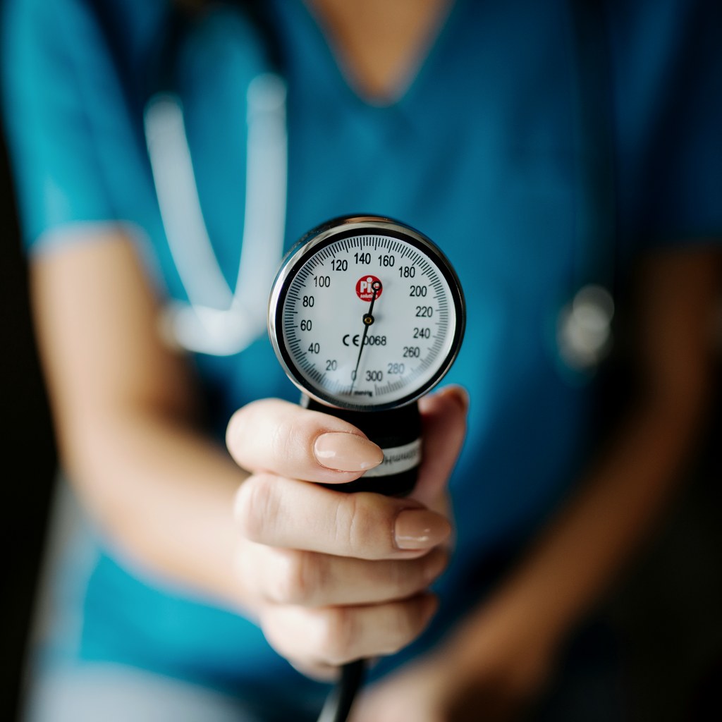 Doctor holding a blood pressure gauge for preoperative medication review before a hair transplant