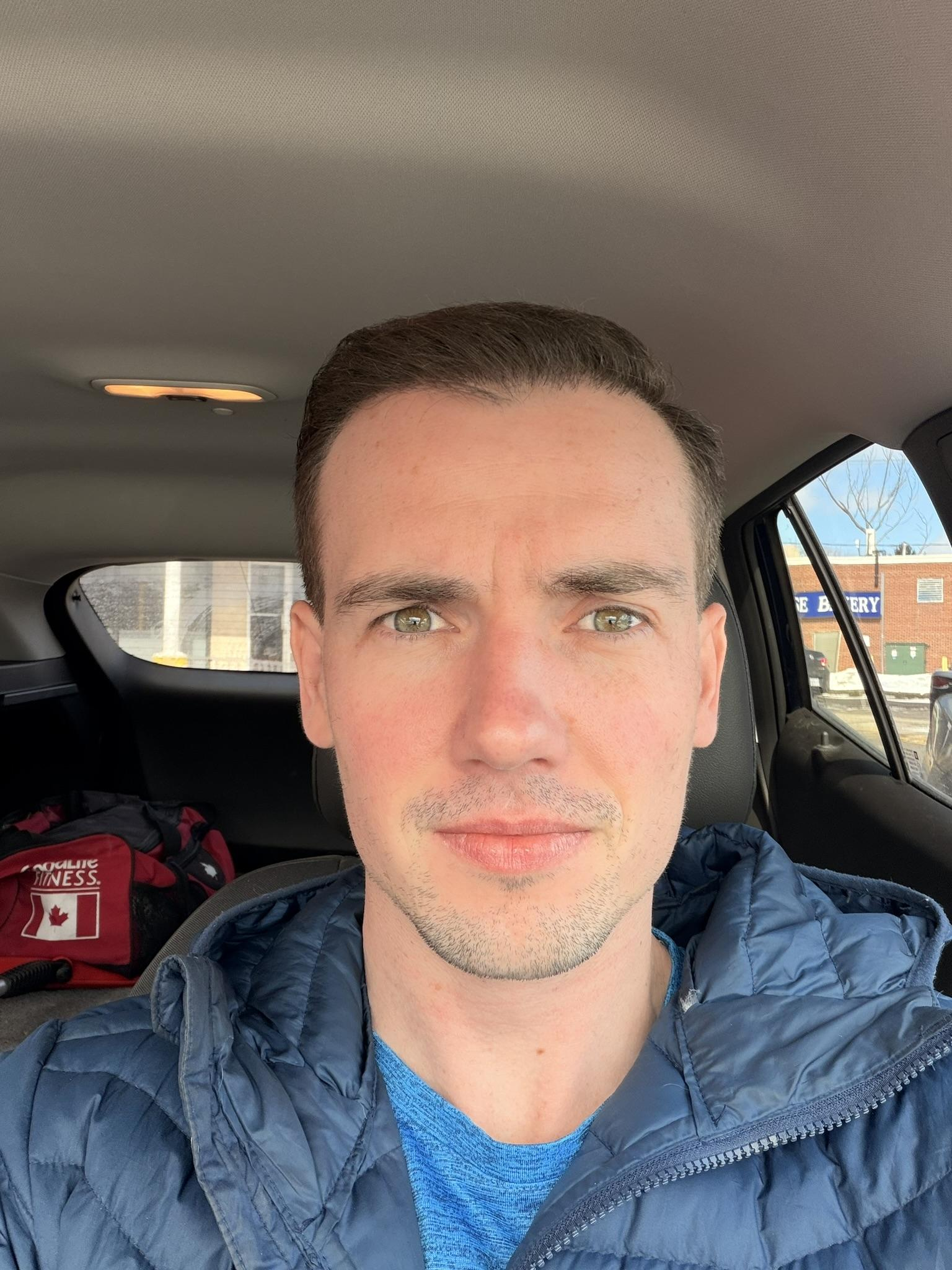 Tyler J. McInnes seated in a car